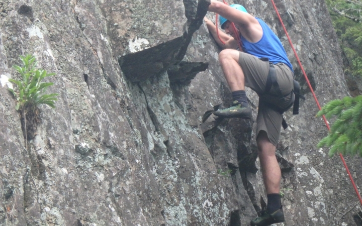 a rock climber navigates a rock wall